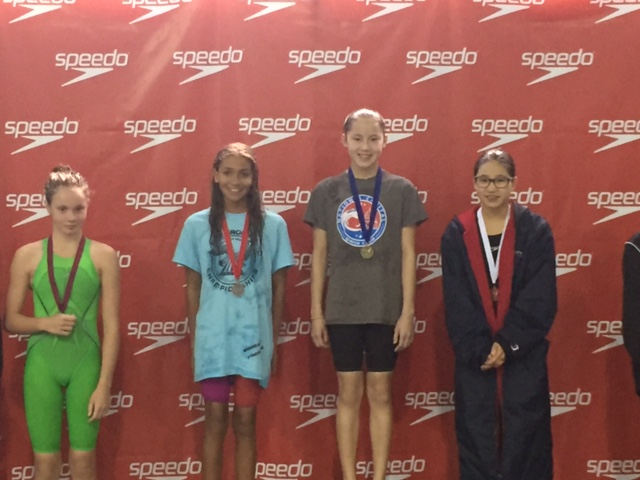 Eleanor Sun atop the podium in 200 Breast